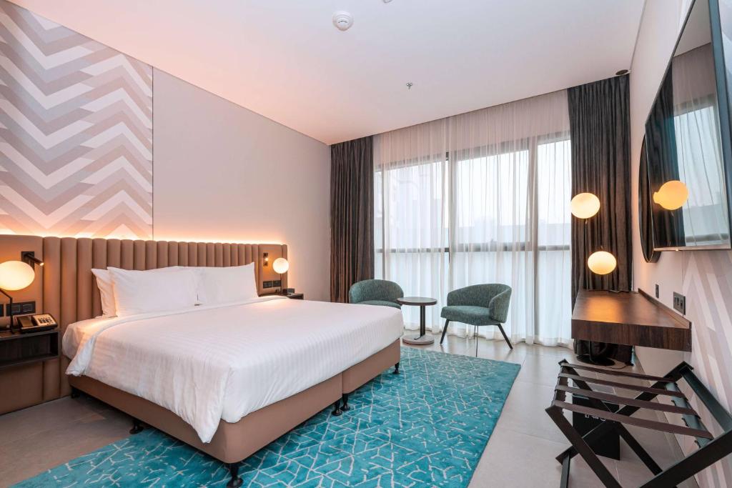 a hotel room with a bed and a desk at Courtyard by Marriott World Trade Centre, Dubai in Dubai
