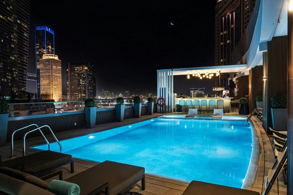 a swimming pool on the roof of a building at night at Courtyard by Marriott World Trade Centre, Dubai in Dubai