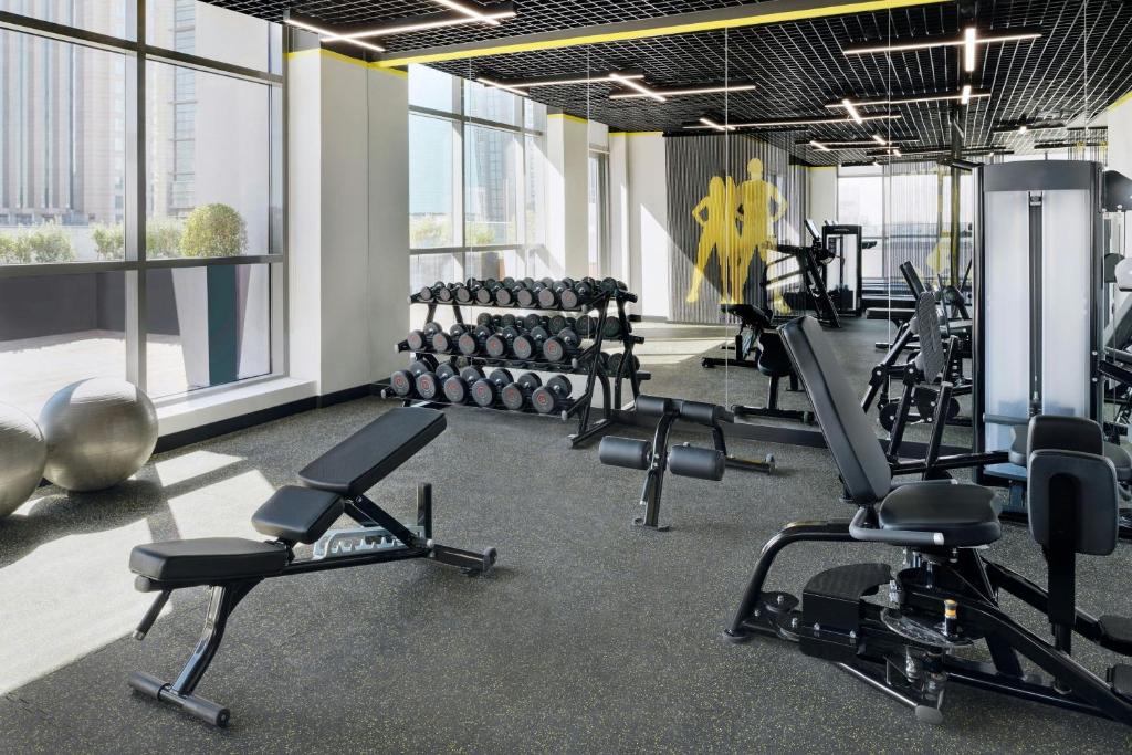 a gym with a lot of treadmills and machines at Courtyard by Marriott World Trade Centre, Dubai in Dubai
