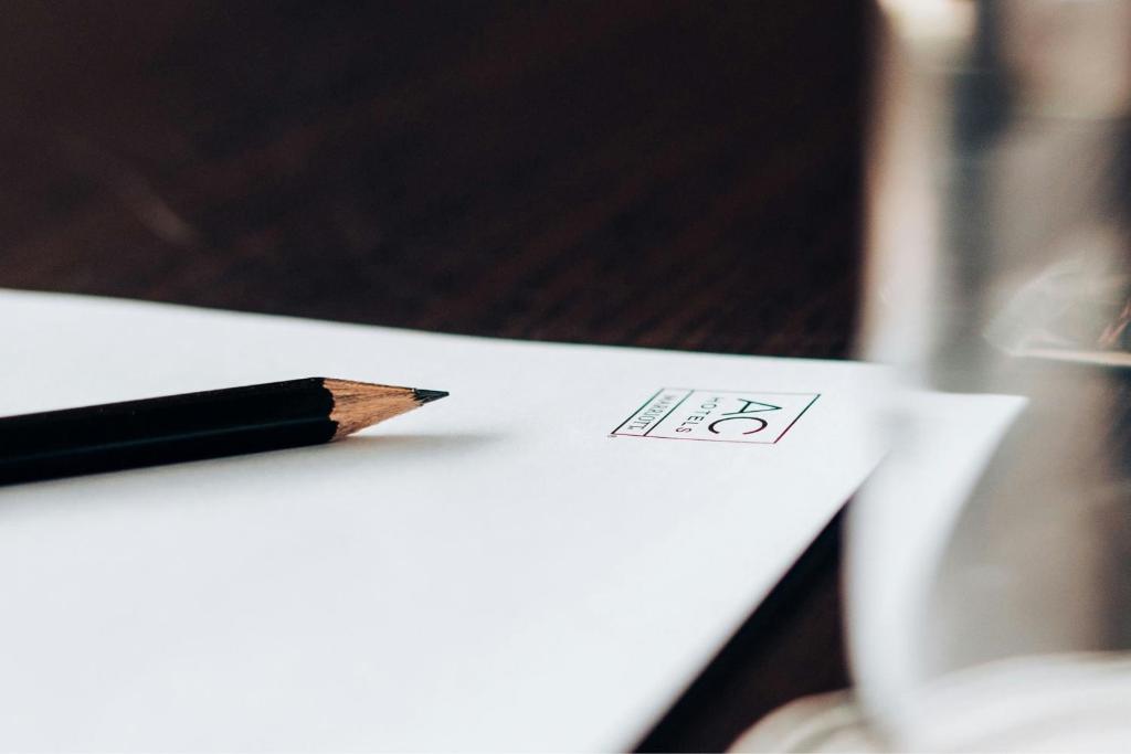 A close-up of a pencil and printed sheet on a tabletop.