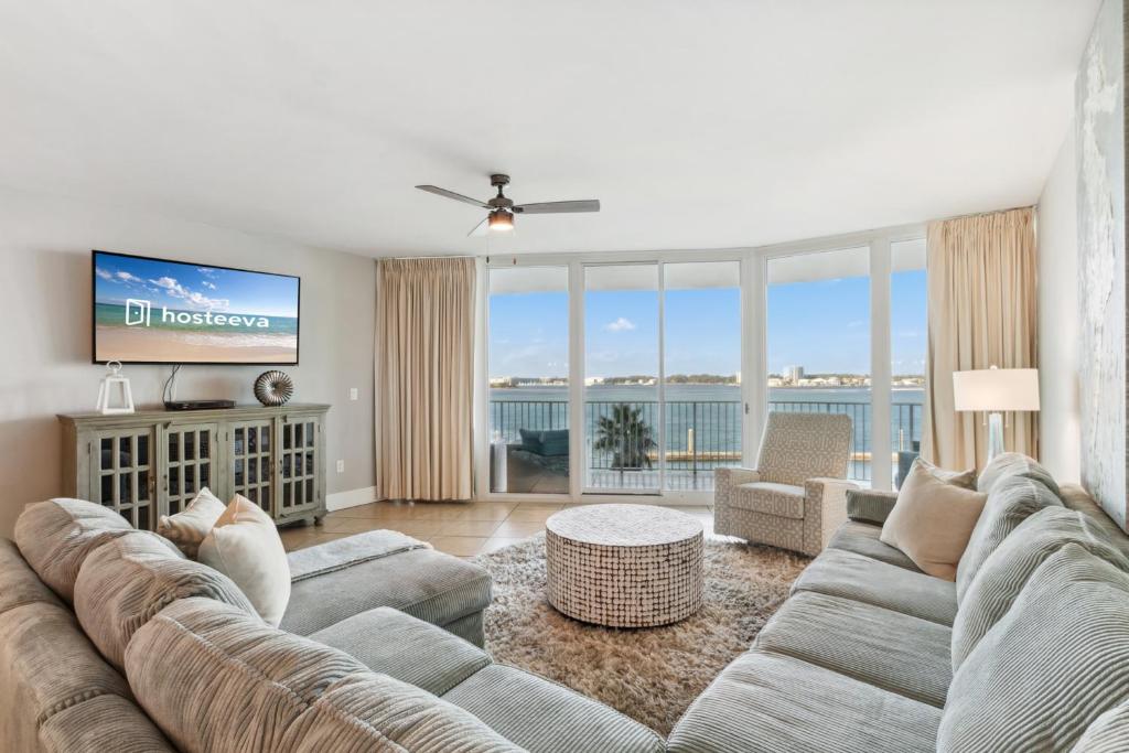 a living room with a large couch and a tv at Caribe 306 C in Orange Beach