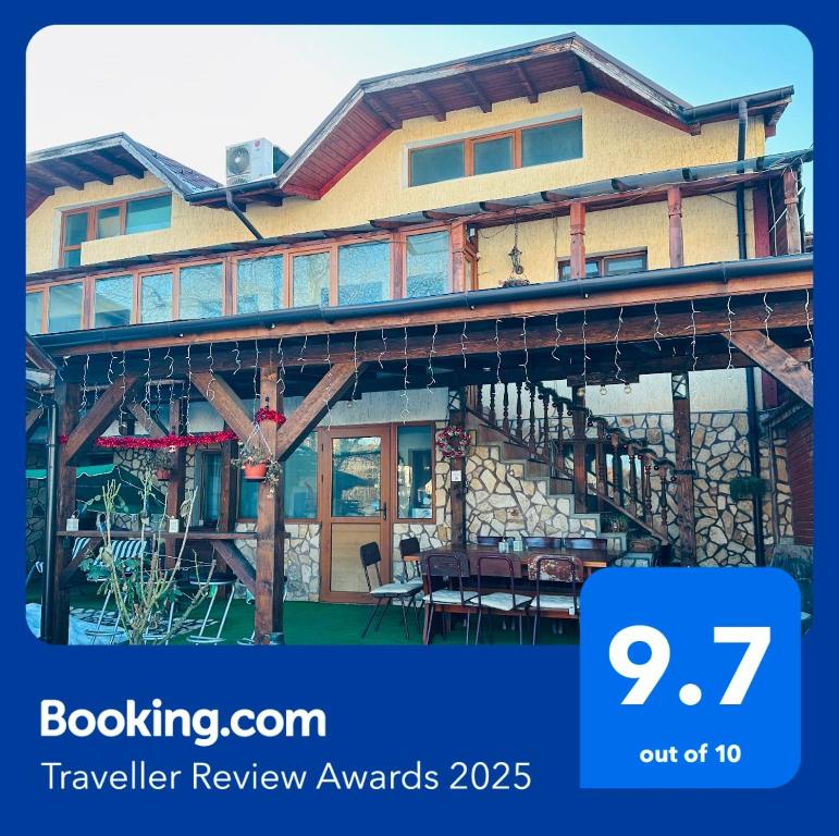 a house with a sign that says travel review awards at Къща за гости Даутев Връх in Bansko