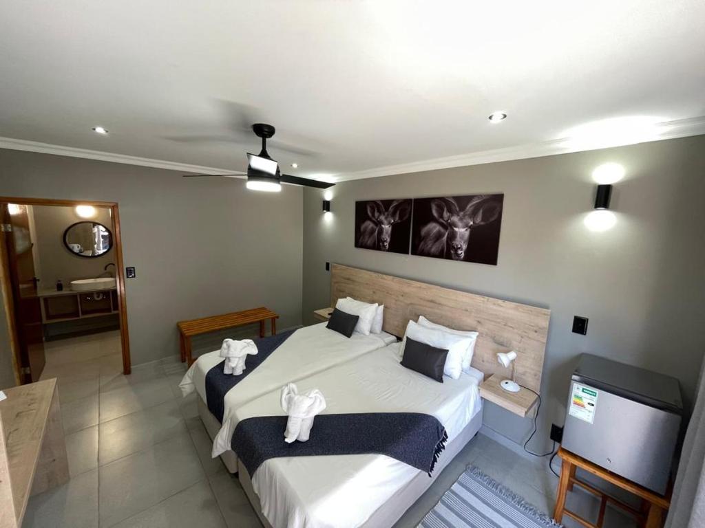 a hotel room with two beds and a television at The Mole Guesthouse in Swakopmund