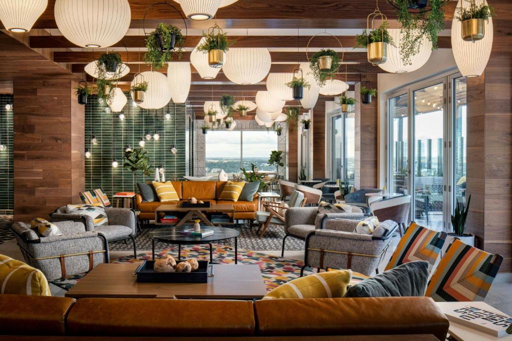 a lobby with couches and tables and windows at Le Meridien Fort Worth Downtown in Fort Worth