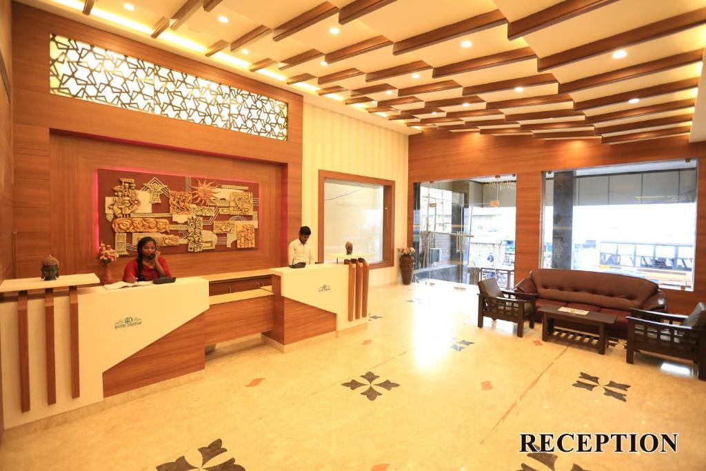 a lobby with a reception desk in a building at Hotel Deepam in Tiruchchirāppalli