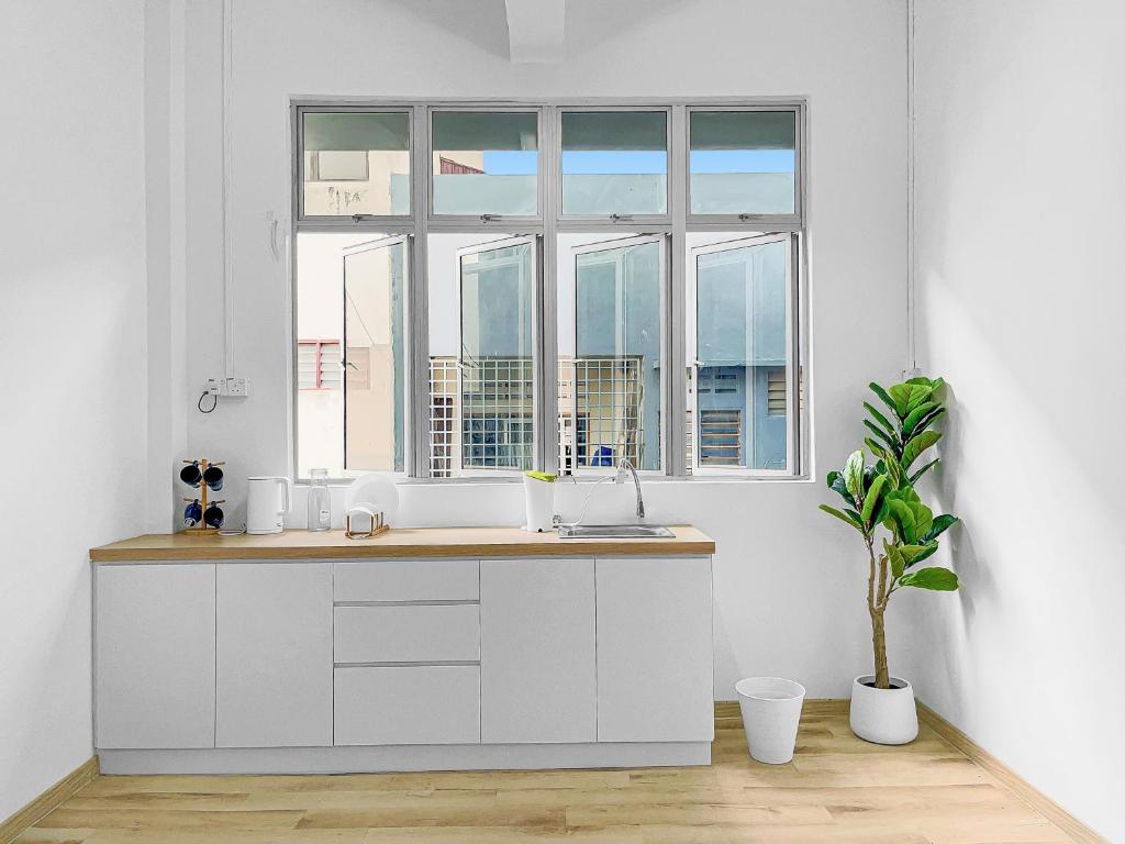 a kitchen with a sink and a window at Yong Peng homestay 永平民宿- 3 Bedroom Shoplot converted BnB at level 1 &2, for business travellers, Street Parking, WIFI, 1 min to KFC & MCD in Yong Peng