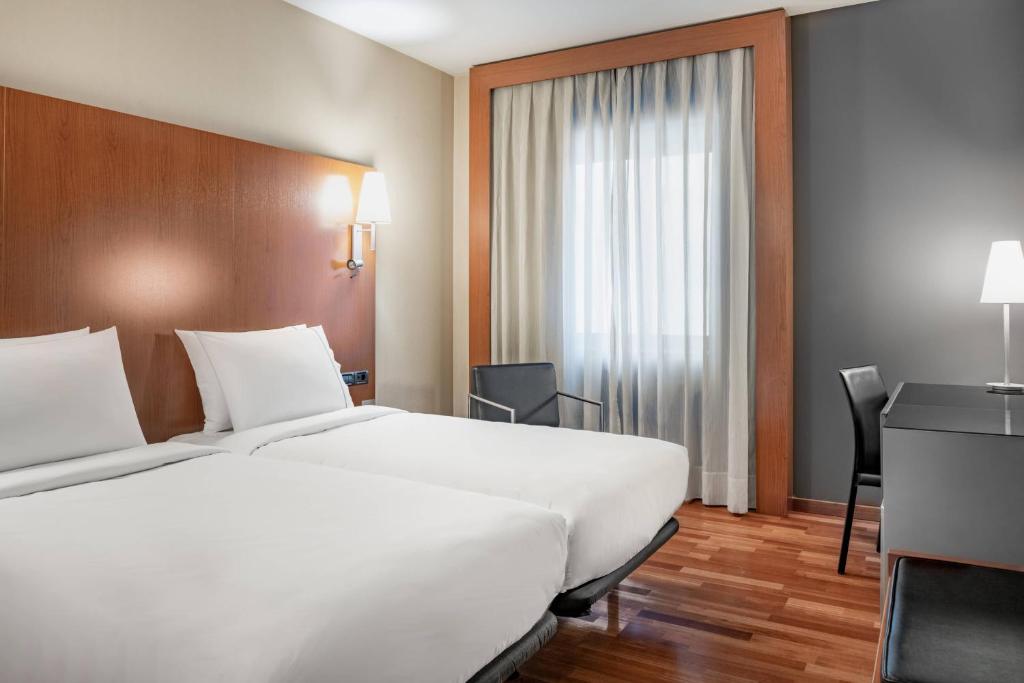 A bed or beds in a room at AC Hotel Ponferrada by Marriott