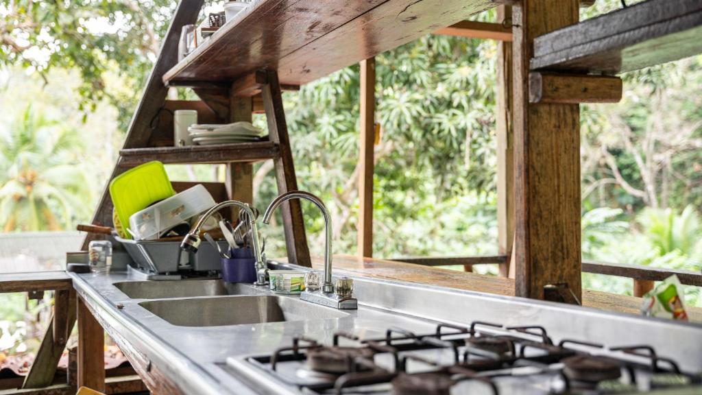 a kitchen with a sink and a stove at Utria hostel in El Valle