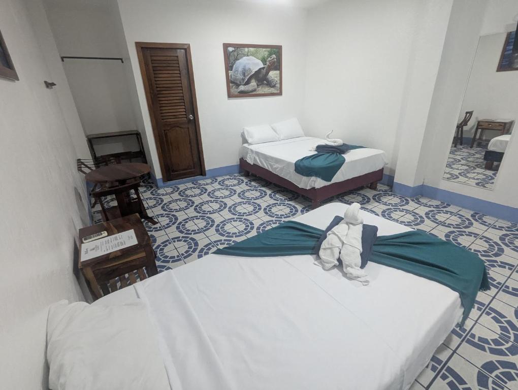 Postel nebo postele na pokoji v ubytování Hostal Gardner