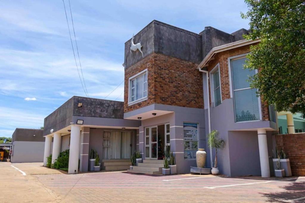 a brick building with a dog on top of it at Mpala Boutique Hotel in Bulawayo