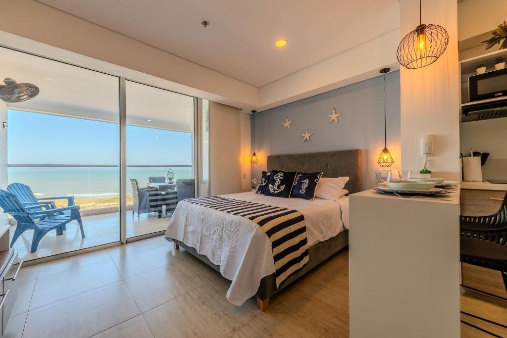 a bedroom with a bed and a view of the ocean at Cartagena Beach Resort 807 in Cartagena de Indias