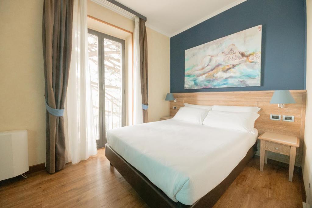 Postel nebo postele na pokoji v ubytování Green Hotel Poggio Regillo