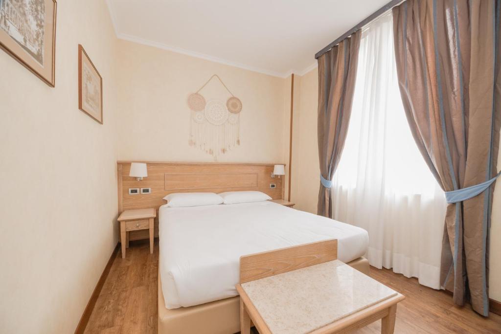 Postel nebo postele na pokoji v ubytování Green Hotel Poggio Regillo