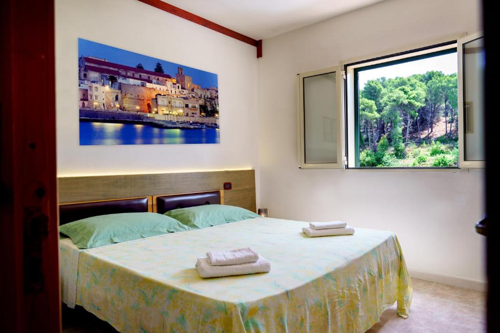 a bedroom with a bed with two towels on it at Residence Atenaion in Otranto
