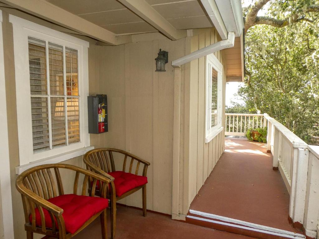 two chairs on the porch of a house at Carmel Dolores Cottages in Carmel