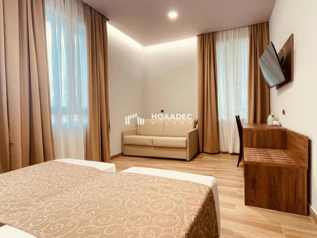 a hotel room with a bed and a couch at CSI Group - Hotel Central Station in Milan