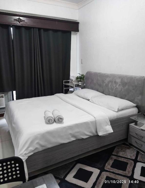 two wedding rings on a bed in a bedroom at Citadel Inn in Manila
