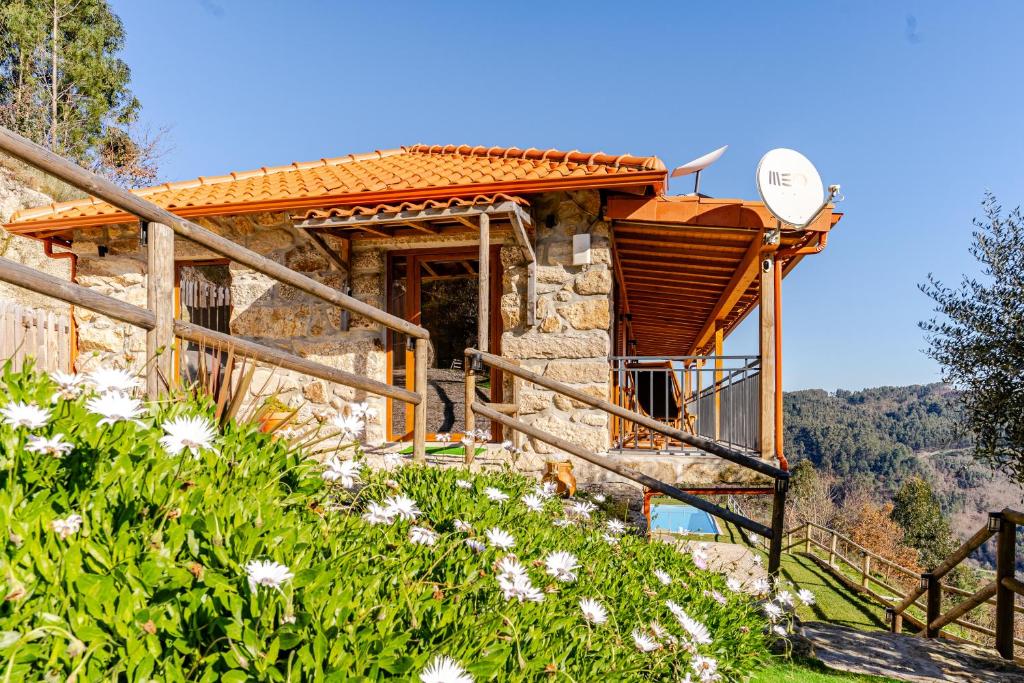 a stone house with a satellite at CASA DO SOL , Turismo Rural in Celorico de Basto