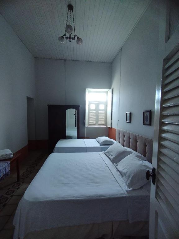Postel nebo postele na pokoji v ubytování Cenário Hostel e Boteco