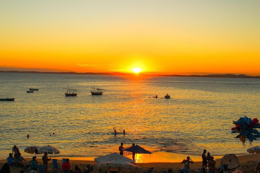 a group of people on a beach at sunset at Apartment in Ondina, Carnival Circuit, Luxury in Salvador
