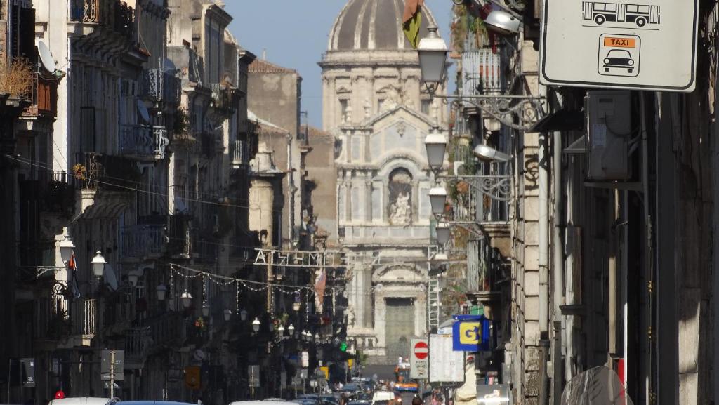 a city street with a building in the distance at Le Case del Cortile in Catania