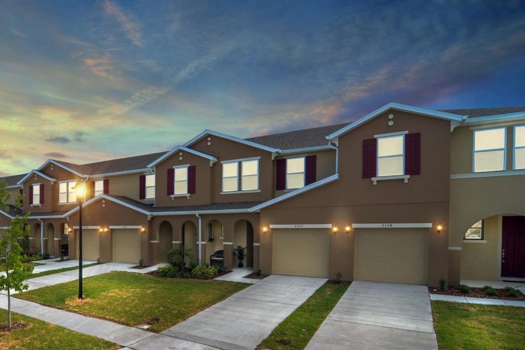 a large house with a driveway in front at Four Bedroom w/ GameRoom 5152A in Kissimmee