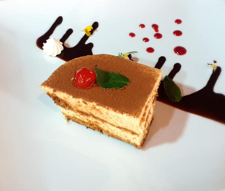 a piece of cake on a white plate with a piece of food at HOTEL & HOSTAL CHIL'IN, Las Trancas in Las Trancas