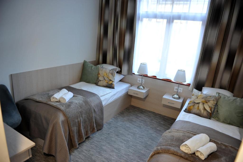 Postel nebo postele na pokoji v ubytování Hotel Három Gúnár