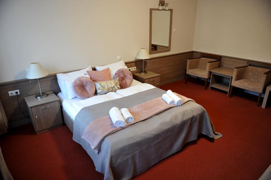 Postel nebo postele na pokoji v ubytování Hotel Három Gúnár