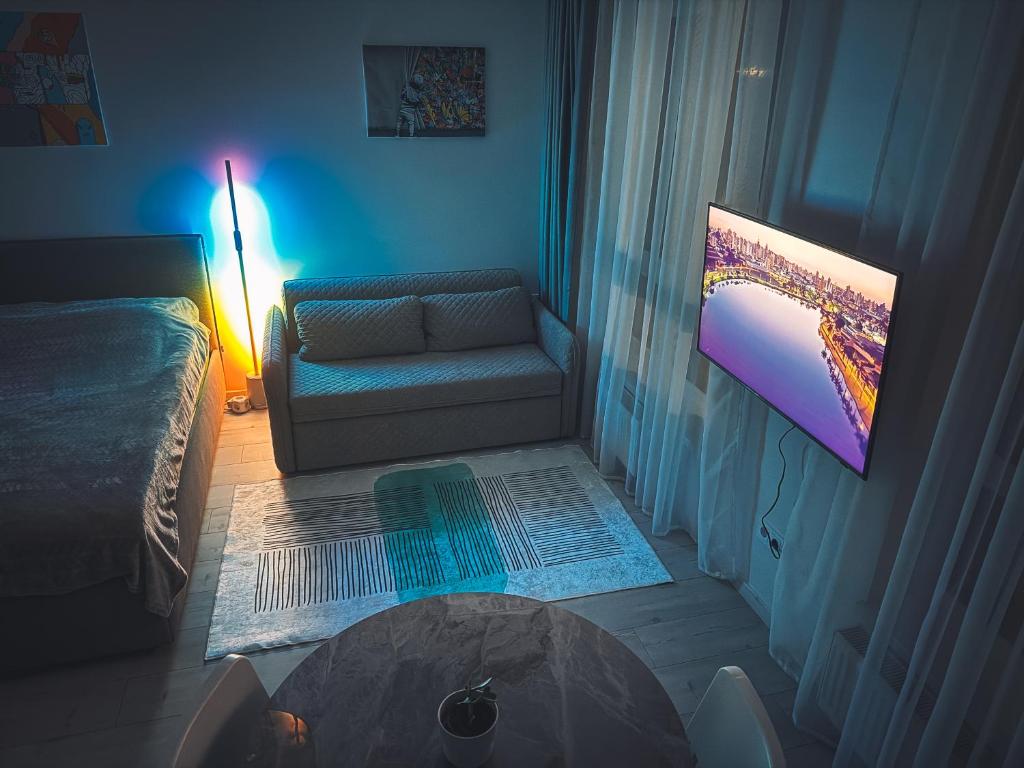 a living room with a couch and a table at Cozy Ozo apartments, free parking! in Vilnius