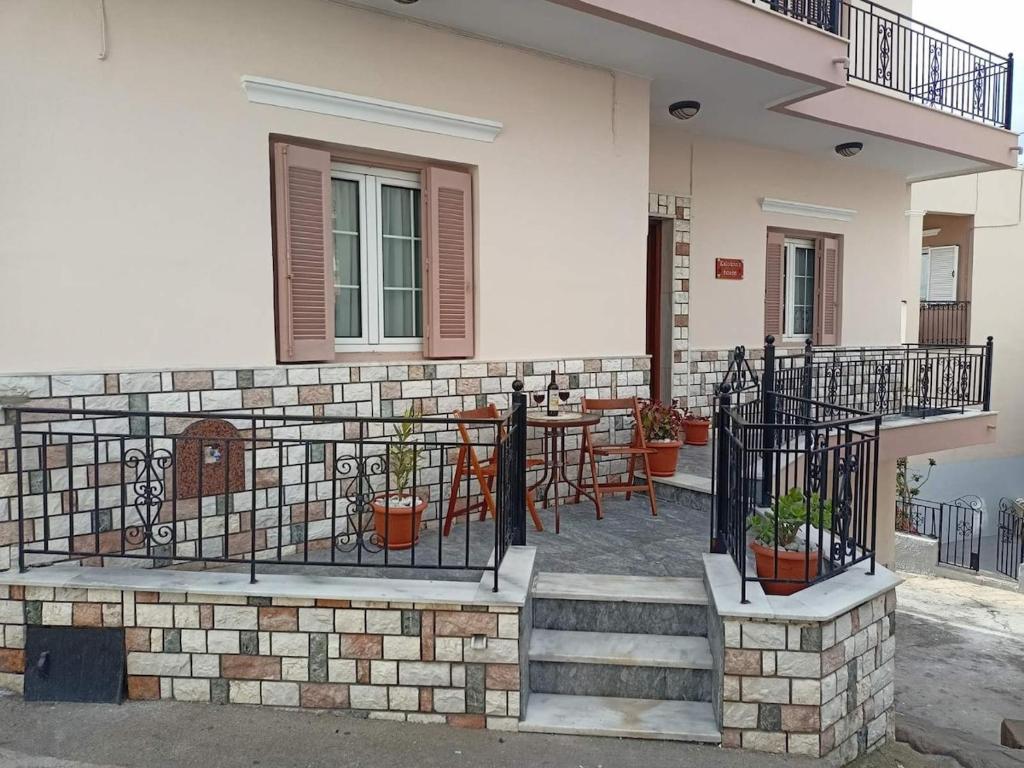 a building with a patio with a table and chairs at Kalotina's House in Kalymnos