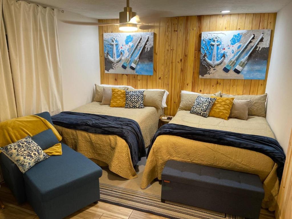 a room with two beds and a chair in it at La Mia Casa II in Sarasota