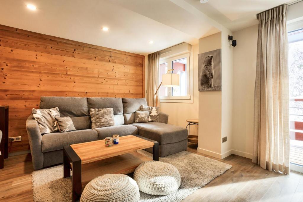 a living room with a couch and a table at Résidence les Chardons - maeva Home - Appartement chaleureux 4 pièces 8 personnes - Prestige - super Home MAE-3341 in Arc 1800