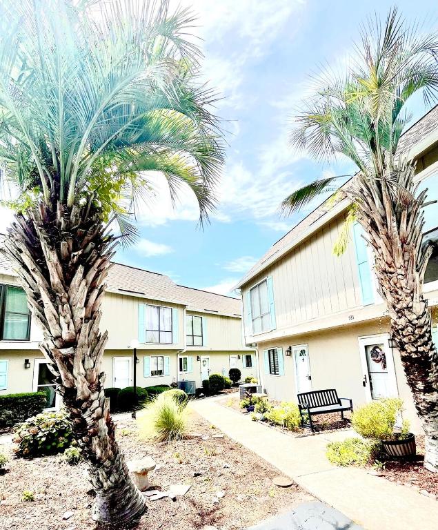 two palm trees in front of a building at The Blue Crab in Myrtle Beach