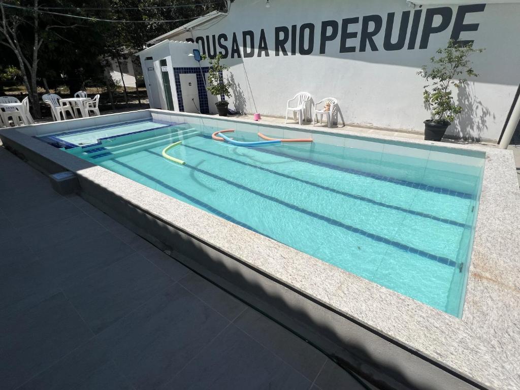 a large swimming pool with blue water in it at Apto com cozinha in Nova Viçosa