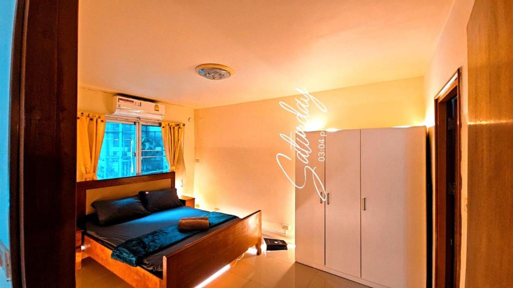 a small bedroom with a bed with a blue sheets at River View Active 6 in Bangkok