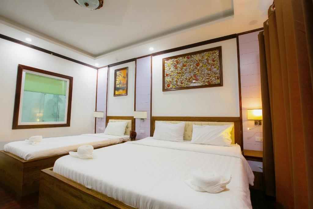 Postel nebo postele na pokoji v ubytování Vientiane Ruby Riverside Hotel