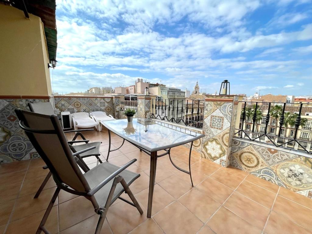 a table and chairs on a balcony with a view at Mini Estudio Málaga in Málaga