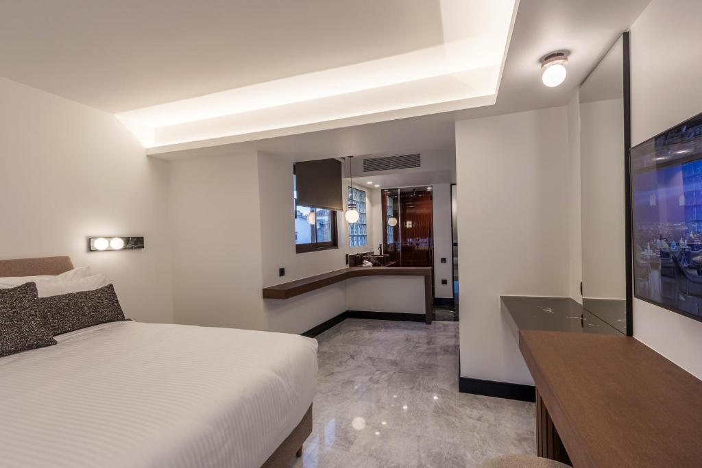 Postel nebo postele na pokoji v ubytování L'Avventura Suites