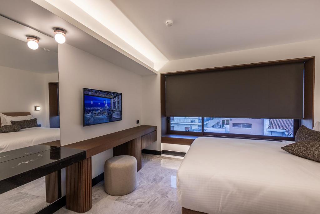 Postel nebo postele na pokoji v ubytování L'Avventura Suites