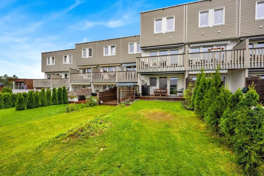 an exterior view of a large apartment building with a yard at Apartment near Oslo, Drammen, and a lake in Lier