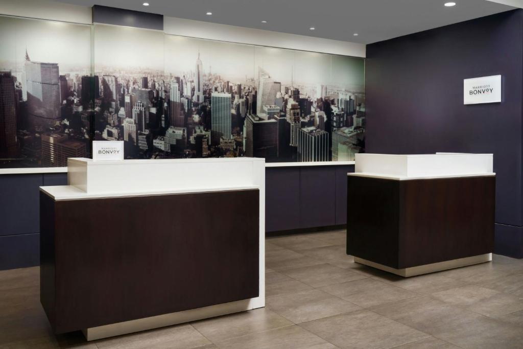 a room with a large painting of a city at Courtyard New York Manhattan/Times Square in New York