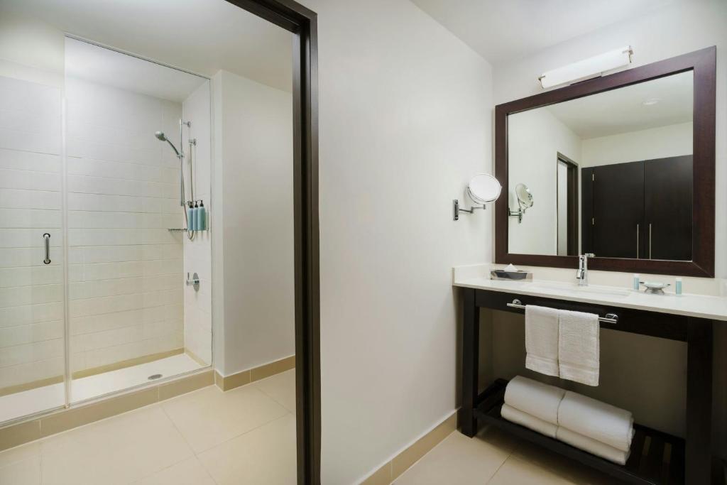 a bathroom with a shower and a sink and a mirror at Courtyard New York Manhattan/Times Square in New York