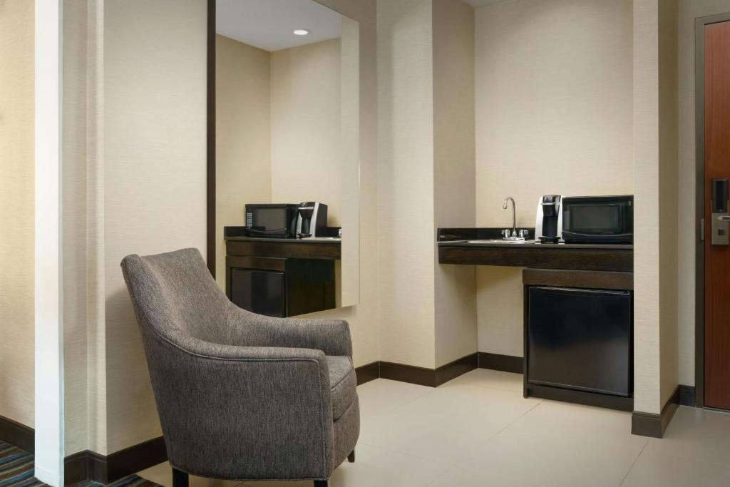 a waiting room with a chair and a microwave at Courtyard New York Manhattan/Times Square in New York