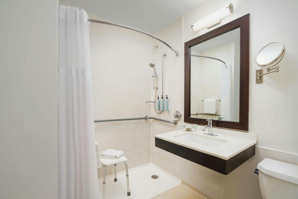 a white bathroom with a sink and a mirror at Courtyard New York Manhattan/Times Square in New York