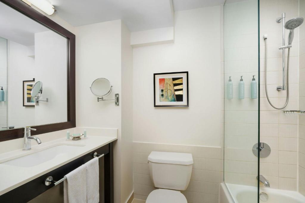 a bathroom with a toilet and a sink and a shower at Courtyard New York Manhattan/Times Square in New York
