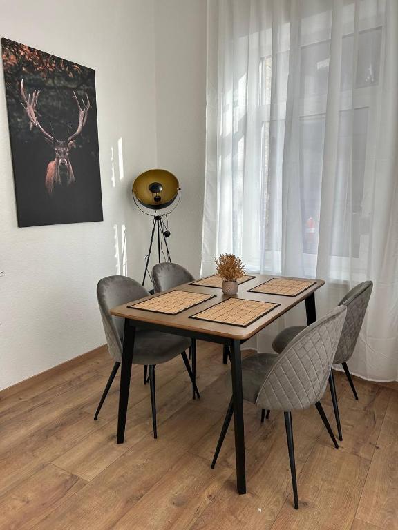 a dining room table and chairs in a room at Lahnblick Deluxe in Lahnstein