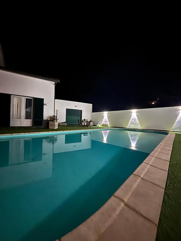 a swimming pool at night with lights at Casa Vereda Ponta Delgada, S Miguel in Ponta Delgada