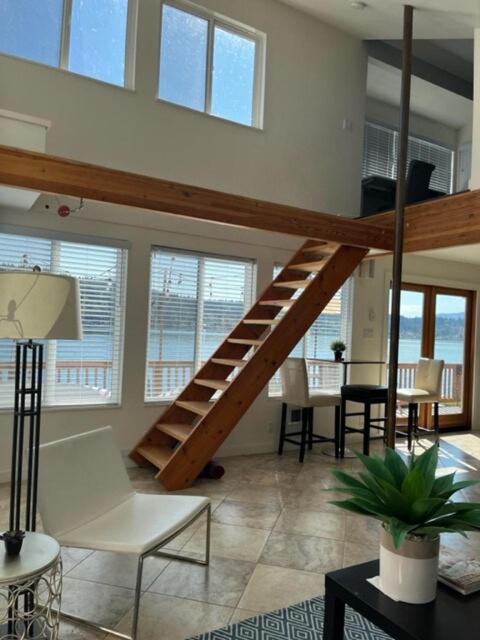 a living room with a staircase in a loft at Lakefront with private beach in Redmond
