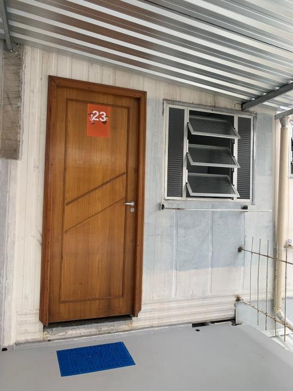 a wooden door and a window in a building at Vila do Chaves Casa da Popis 23 in Itajaí